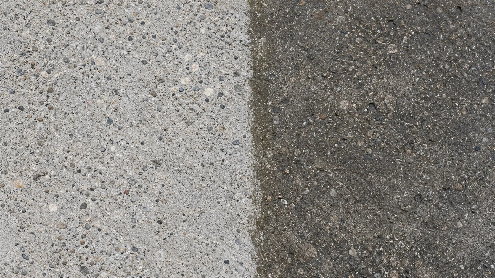 Close-up surface study of the clean and unwashed halves of gray concrete